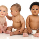Three babies from different backgrounds, in nappies